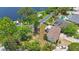 Aerial view of a home with mature trees and a nearby lake enhancing the property's tranquil and picturesque setting at 12803 126Th Ter, Largo, FL 33774