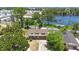 Aerial view of a home near a lake, surrounded by lush greenery and neighboring houses in a serene setting at 12803 126Th Ter, Largo, FL 33774