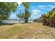 Spacious backyard with green grass and a white fence, perfect for outdoor activities at 12803 126Th Ter, Largo, FL 33774