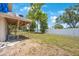 The backyard features ample green space, a covered patio and a white fence at 12803 126Th Ter, Largo, FL 33774