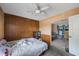 Bedroom featuring wood-paneled walls and view into adjacent living room at 12803 126Th Ter, Largo, FL 33774