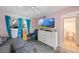 Bright bedroom featuring a TV, dresser, and an attached bathroom at 12803 126Th Ter, Largo, FL 33774