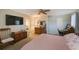 Bedroom with a ceiling fan, dresser, and a workstation area at 12803 126Th Ter, Largo, FL 33774
