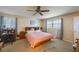 Cozy bedroom with a ceiling fan, window with natural light, and comfortable furnishings at 12803 126Th Ter, Largo, FL 33774