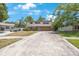 Charming two-story home featuring a stone-accented base and a spacious driveway under a clear blue sky at 12803 126Th Ter, Largo, FL 33774