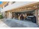 Stone-clad garage with an open door and a cluttered interior at 12803 126Th Ter, Largo, FL 33774