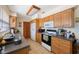 Functional kitchen with wood cabinets, appliances, and ample counter space at 12803 126Th Ter, Largo, FL 33774