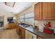 Well-lit kitchen featuring wood cabinets and countertops, with a view to the living room at 12803 126Th Ter, Largo, FL 33774