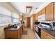 Efficient kitchen with wooden cabinetry, ample counter space, and essential appliances at 12803 126Th Ter, Largo, FL 33774
