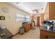 Functional kitchen with wood cabinets, a window over the sink, and tiled floors at 12803 126Th Ter, Largo, FL 33774
