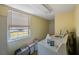 Functional laundry room with a window providing natural light and essential appliances at 12803 126Th Ter, Largo, FL 33774