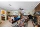 Spacious living room with tile flooring, cozy seating, and a brick fireplace at 12803 126Th Ter, Largo, FL 33774