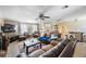 Inviting living room with plush leather furnishings, ceiling fan, and neutral decor at 12803 126Th Ter, Largo, FL 33774