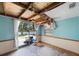Damaged room with peeling ceiling and view of a lake through sliding glass door at 12803 126Th Ter, Largo, FL 33774