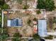 Aerial view shows a property with fenced yard and multiple outbuildings at 1412 Coburn Dr, Tarpon Springs, FL 34689