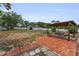 Spacious backyard featuring a patio, a shed, a large grassy area, and privacy fencing at 1412 Coburn Dr, Tarpon Springs, FL 34689