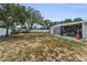 Large backyard with a fence and a storage shed, offering ample space at 1412 Coburn Dr, Tarpon Springs, FL 34689