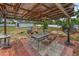 Cozy backyard patio with outdoor seating, a fire pit, and a spacious yard at 1412 Coburn Dr, Tarpon Springs, FL 34689