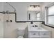 Charming bathroom features a shower, toilet, vanity, and classic black and white tile at 1412 Coburn Dr, Tarpon Springs, FL 34689