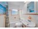 Clean bathroom with white fixtures, a tub, and a charming ocean-themed shower curtain at 1412 Coburn Dr, Tarpon Springs, FL 34689