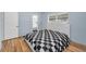 Bedroom featuring light blue walls, a black and white comforter, and bright windows at 1412 Coburn Dr, Tarpon Springs, FL 34689