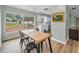 Inviting dining area featuring wood-look flooring, a ceiling fan, and a backyard view at 1412 Coburn Dr, Tarpon Springs, FL 34689