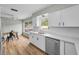 Beautiful kitchen with white cabinets, stainless steel appliances, and bright natural lighting at 1412 Coburn Dr, Tarpon Springs, FL 34689