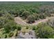 Expansive aerial view of treed acreage surrounding single-Gathering home with sprawling lush landscape at 14223 Lambert Bridge Ln, Lithia, FL 33547