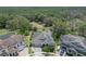 Aerial view of home, mature trees, and solar panels in an established neighborhood at 14223 Lambert Bridge Ln, Lithia, FL 33547
