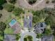 An aerial view displays the layout of multiple houses, driveways, and landscaping in a planned community at 14223 Lambert Bridge Ln, Lithia, FL 33547