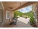 Covered back patio features a ceiling fan and overlooks an outdoor fire pit with seating, perfect for entertaining at 14223 Lambert Bridge Ln, Lithia, FL 33547