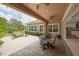 Extended back patio featuring a covered seating area with outdoor fan and an open fire pit area at 14223 Lambert Bridge Ln, Lithia, FL 33547