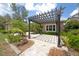 Inviting backyard with a pergola, brick pavers, and lush landscaping creates a perfect outdoor retreat at 14223 Lambert Bridge Ln, Lithia, FL 33547
