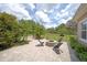 Relaxing backyard patio featuring a stone fire pit and comfortable seating at 14223 Lambert Bridge Ln, Lithia, FL 33547