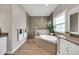 Bright bathroom with a tiled shower, soaking tub, and modern fixtures creating a spa-like experience at 14223 Lambert Bridge Ln, Lithia, FL 33547