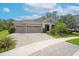 Inviting home featuring a brick-paved driveway, well-maintained landscaping, and an elegant entrance at 14223 Lambert Bridge Ln, Lithia, FL 33547