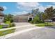 Attractive home boasts a three-car garage, beautiful landscaping, and a welcoming front entrance at 14223 Lambert Bridge Ln, Lithia, FL 33547