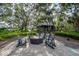Community fire pit with seating, set near the lake for a relaxing outdoor gathering space at 14223 Lambert Bridge Ln, Lithia, FL 33547