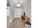 Bright foyer with wood-look tile, a stylish light fixture, and a hall table at 14223 Lambert Bridge Ln, Lithia, FL 33547