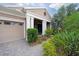 Welcoming front porch with elegant columns and well-maintained landscaping at 14223 Lambert Bridge Ln, Lithia, FL 33547