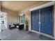 Inviting front porch with seating area and elegant double-door entrance at 14223 Lambert Bridge Ln, Lithia, FL 33547