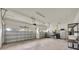 Spacious three car garage with ample storage, overhead lighting, and a convenient workspace at 14223 Lambert Bridge Ln, Lithia, FL 33547