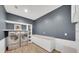 Functional laundry room with sleek front-load washer and dryer, built-in shelving, and ample counter space at 14223 Lambert Bridge Ln, Lithia, FL 33547