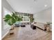 Cozy living room features a built-in bookcase, a comfortable couch, and ample lighting at 14223 Lambert Bridge Ln, Lithia, FL 33547