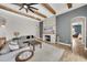 Open-concept living room featuring beamed ceilings, fireplace, and access to the bedroom at 14223 Lambert Bridge Ln, Lithia, FL 33547