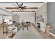 Open-concept living room with beamed ceilings and fireplace adjacent to the kitchen at 14223 Lambert Bridge Ln, Lithia, FL 33547
