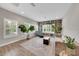 Bright living room features a built-in bookcase, a comfortable couch, and many windows at 14223 Lambert Bridge Ln, Lithia, FL 33547