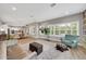 Bright living room features a built-in bookcase, a comfortable couch, and ample lighting at 14223 Lambert Bridge Ln, Lithia, FL 33547