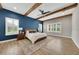 Spacious main bedroom features a king-size bed, wooden ceiling beams, and plantation shutters at 14223 Lambert Bridge Ln, Lithia, FL 33547