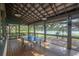 Spacious recreation room offering ping pong and serene lake views through screened windows at 14223 Lambert Bridge Ln, Lithia, FL 33547